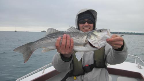 Joseph Lee with a hard won Bass on the fly......, 2015